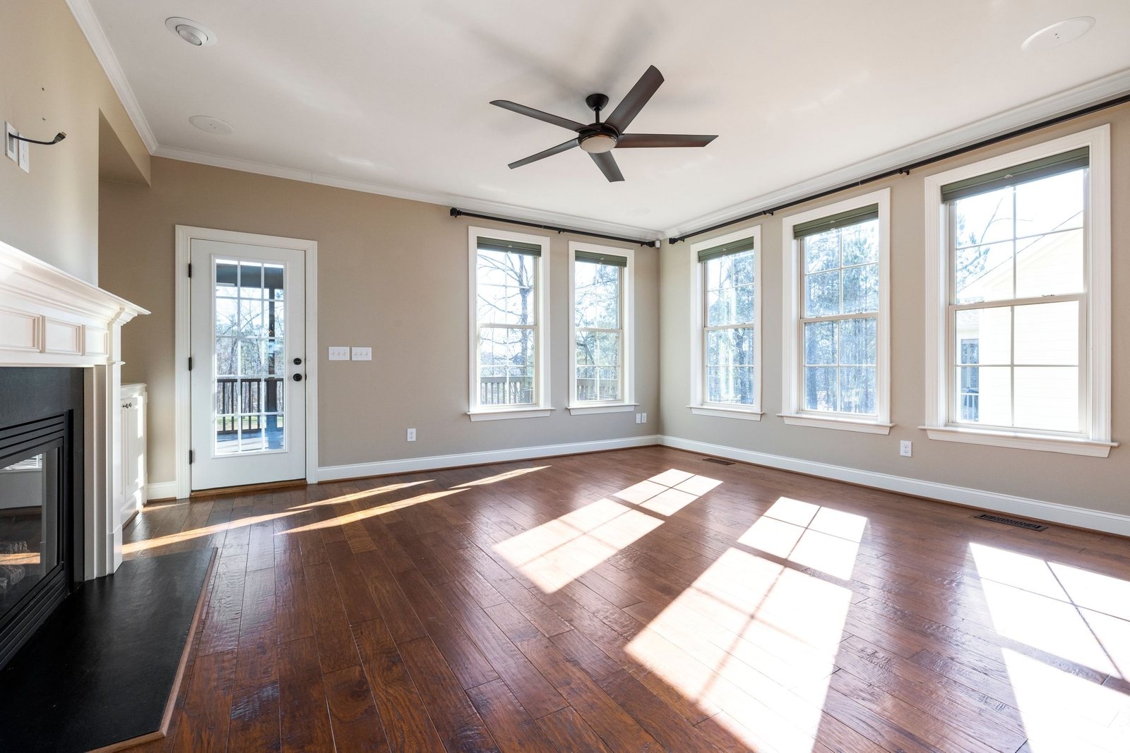 Bare floors cleaned in a sunlit empty room